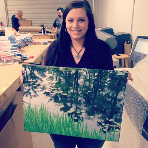 Jessica holding a wrapped canvas print