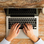 Picture of woman hands with laptop purchased at Canva