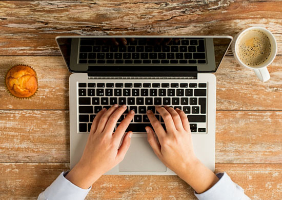 Picture of woman hands with laptop purchased at Canva