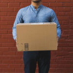 Shipping delivery person holding box