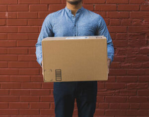 Shipping delivery person holding box